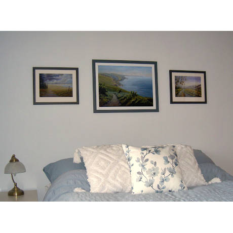 welsh prints of llangrannog and west wales hanging on the wall