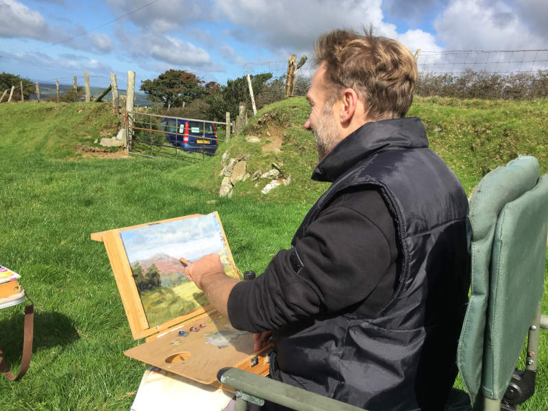 Chris Chalk painting outdoors in the Preseli hills of Pembrokeshire using his pochade box.