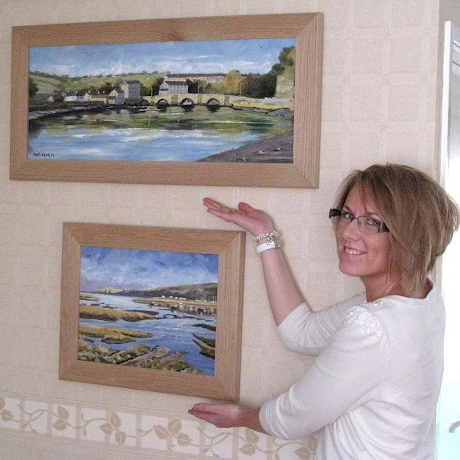 Happy client with her framed paintings